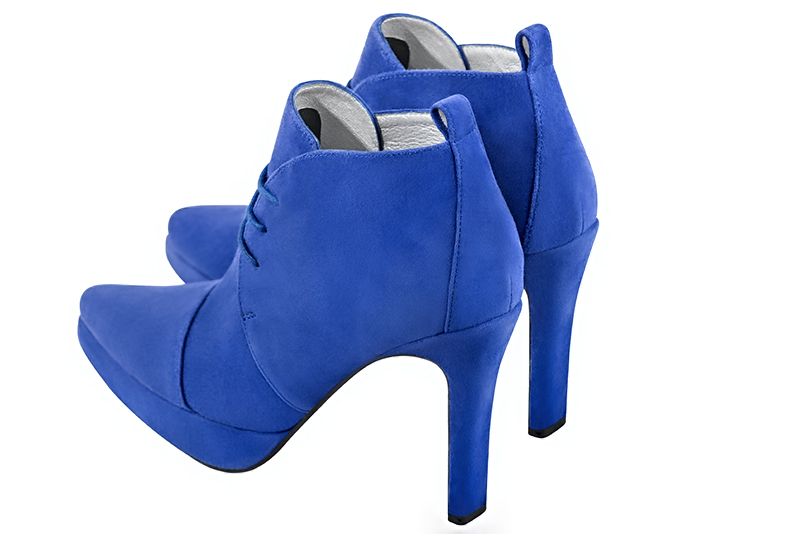Electric blue women's ankle boots with laces at the front. Tapered toe. Very high slim heel with a platform at the front. Rear view - Florence KOOIJMAN